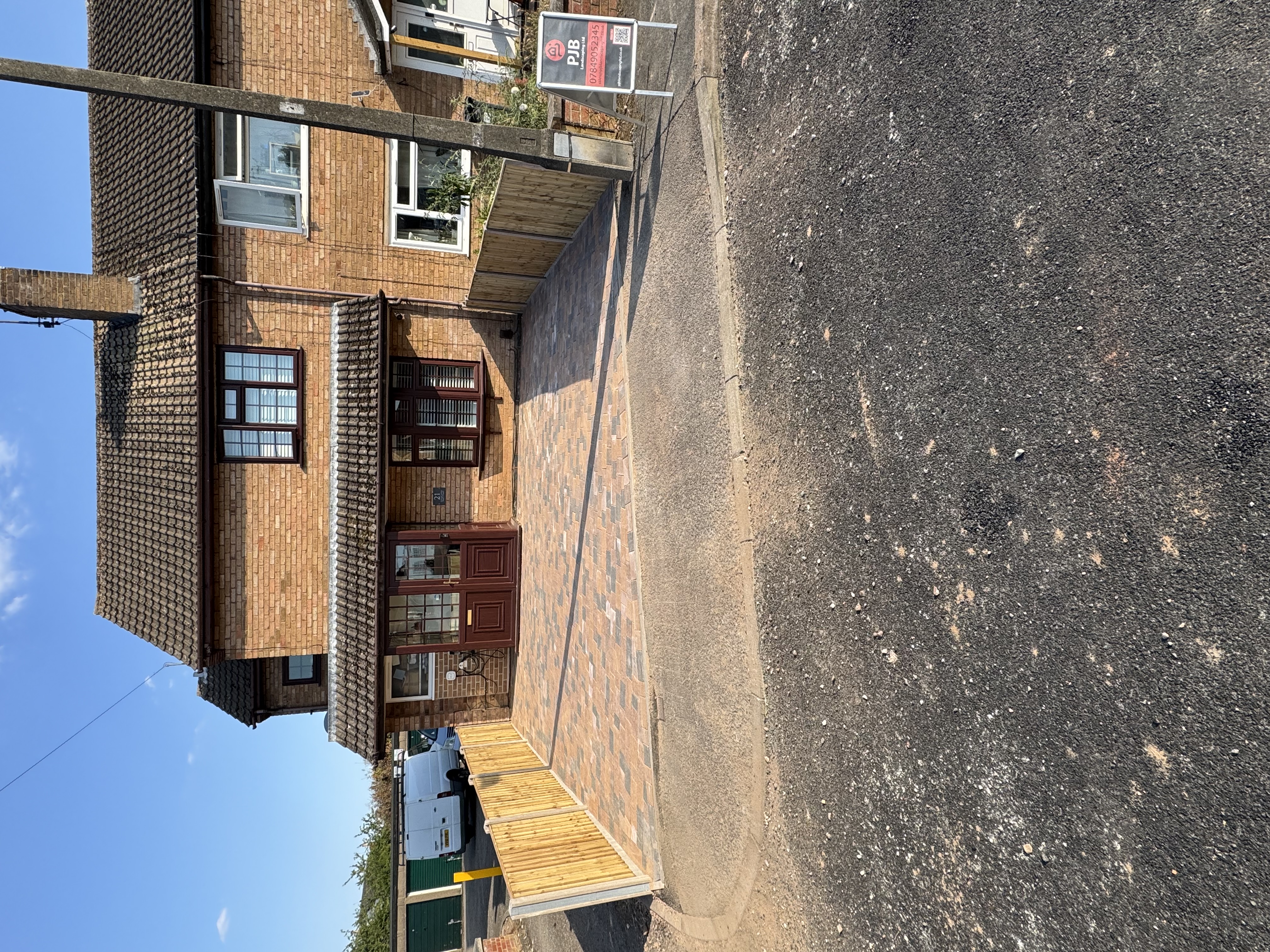 Block paved driveway with fence